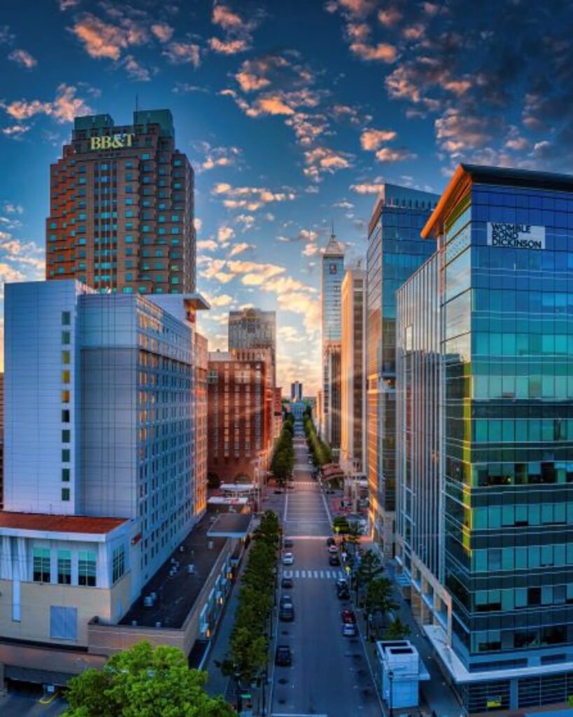 Raleigh downtown skyline with modern buildings and green spaces - Cura Maids serves this area.